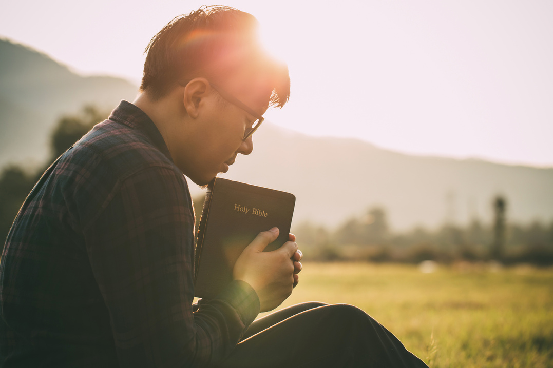 Sunday readings, Bible.male holding Bible with nature view